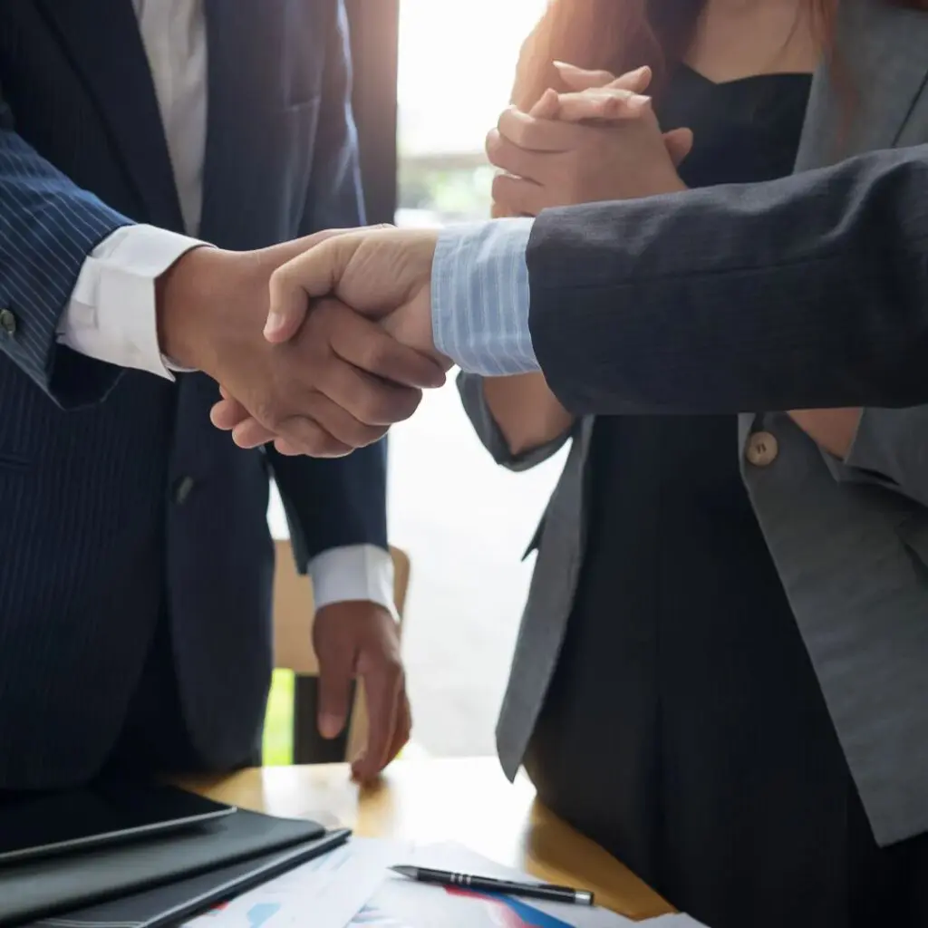 two men in formal suits handshaking